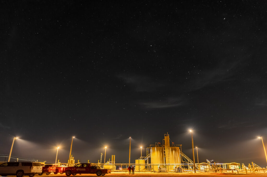 Oil and gas facility illuminated by night sky friendly lighting.