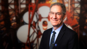 Portrait of Daniel Jaffe in front of the Giant Magellan Telescope.