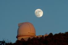A nearly full gibbous Moon shines at sunset over the dome of the 2.7-meter (107-