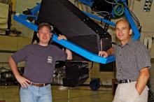 Instrument-building astronomers Gary Hill (left) and Phillip MacQueen pose with 