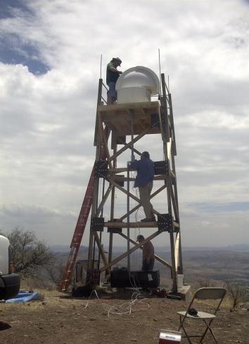 University of New Mexico research faculty members and a student install a fully 