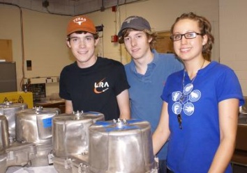 Students Andrew Peterson (left) and Ingrid Johnson (right), with Research Associate Trent Peterson (center), at work in the lab.