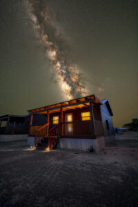 Milky Way over a cabin.